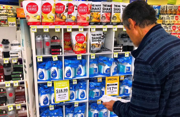 A customer looks at products marked with discounted prices on display at a chemist in a shopping mall in central Sydney, Australia, July 25, 2018.    