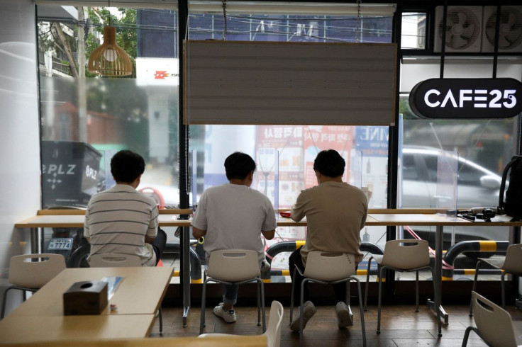 Office workers eat their lunch at a convenience store in Seoul, South Korea, June 24, 2022.