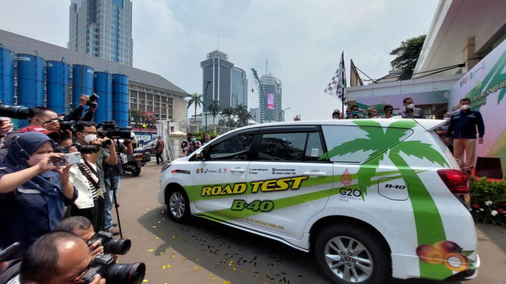 People take pictures of a car road test for fuel with 40% palm based biodiesel blending at a Ministry of Energy and Mineral Resources area in Jakarta, Indonesia, July 27, 2022.