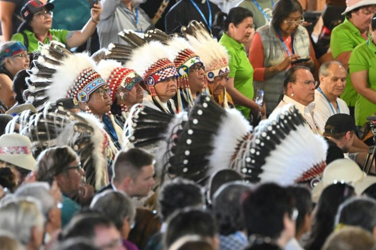 Indigenous community members listen to Pope Francis give a liturgy at  at Lac Ste. Anne, northwest of Edmonton, Alberta, Canada, July 26, 2022