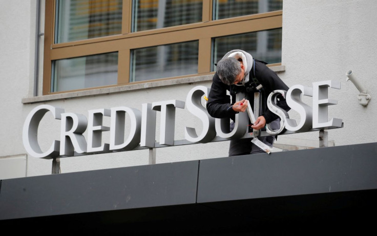 A worker repairs the logo of Swiss bank Credit Suisse at a branch in Zurich, Switzerland November 1, 2018.