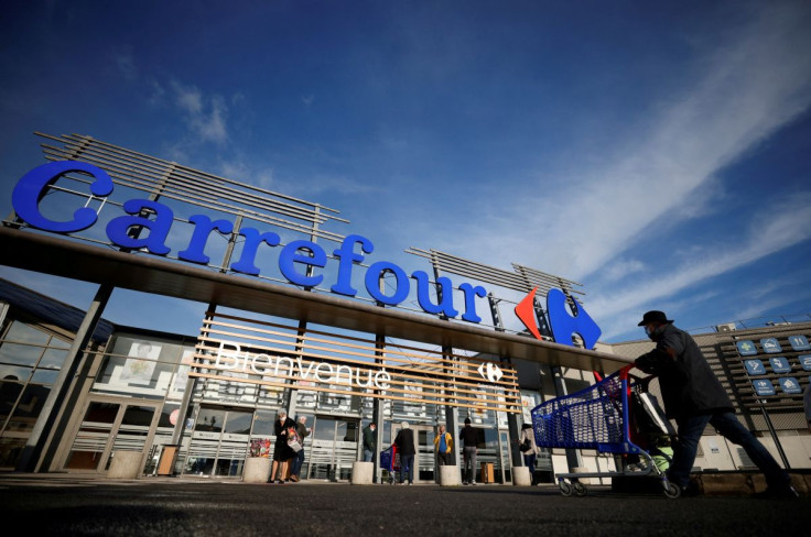 A customer pushes his shopping trolley in front of a Carrefour Hypermarket store in Saint-Herblain near Nantes, France January 15, 2021.
