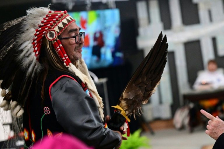 An Indigenous community member speaks to clergy members prior to a visit from Pope Francis, at the Citadel of Quebec in Quebec City, Canada, on July 27, 2022