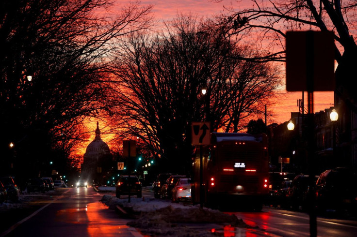 The sunset lights up the sky behind the U.S. Capitol dome on the eve of the first anniversary of the January 6th attack on the Capitol, in Washington, U.S. January 5, 2022.  