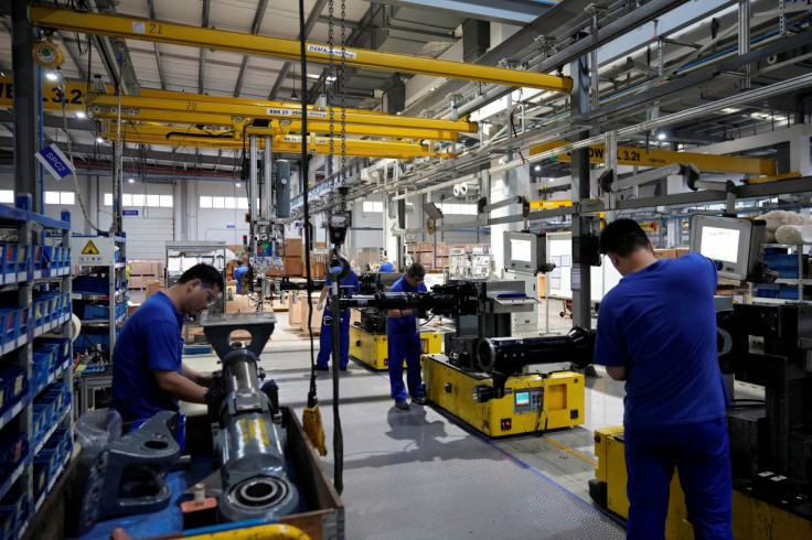 Employees work on theÂ production line of vehicle componentsÂ during a government-organised media tour to a factory of German engineering group Voith, following the coronavirus disease (COVID-19) outbreak, in Shanghai, China July 21, 2022. 
