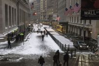 Commuters walk through the Financial District during a snow storm in Lower Manhattan, New York, January 26, 2015.  