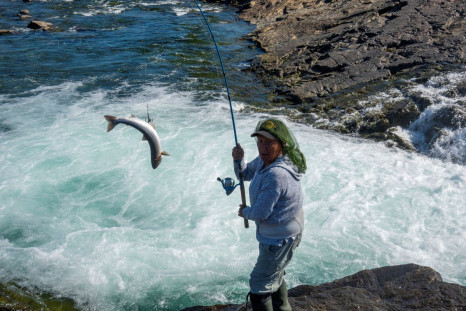Oolootie Kunilusie reels in an Arctic char from the Sylvia Grinnell River ahead of the visit by Pope Francis to Iqaluit, Nunavut, Canada July 27, 2022. 