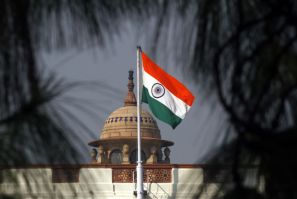 An Indian national flag flutters on top of the Indian parliament building in New Delhi December 1, 2010. 