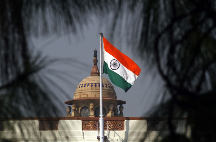 An Indian national flag flutters on top of the Indian parliament building in New Delhi December 1, 2010. 