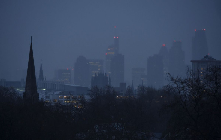 The City of London business district is seen in the distance behind church spires at dawn in London, Britain January 8, 2015.
