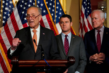 U.S. Senate Majority Leader Chuck Schumer (D-NY) speaks as U.S. Senators Todd Young (R-IN) and John Cornyn (R-TX) listen during a news conference after the U.S. Senate passed legislation to subsidize the domestic semiconductor industry, at the U.S. Capito
