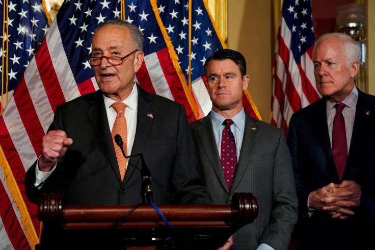 U.S. Senate Majority Leader Chuck Schumer (D-NY) speaks as U.S. Senators Todd Young (R-IN) and John Cornyn (R-TX) listen during a news conference after the U.S. Senate passed legislation to subsidize the domestic semiconductor industry, at the U.S. Capito