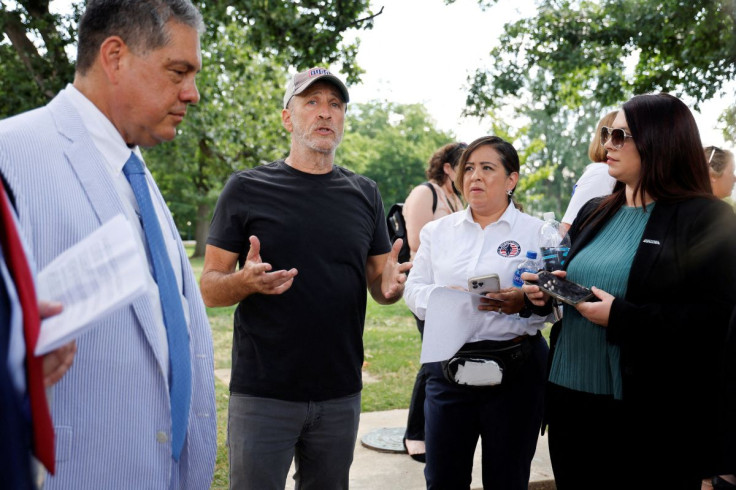 Comedian Jon Stewart speaks with fellow activists after Republican senators stalled a bill aimed at giving greater healthcare access to U.S. military veterans exposed to toxic burn pits, before a news conference with the bill's supporters at the U.S. Capi