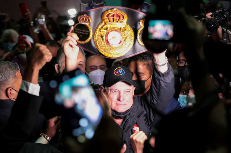 Former Panamanian president Ricardo Martinelli holds up a boxing belt while leaving a courthouse where he was acquitted on tapping charges in Panama City, Panama November 9, 2021.