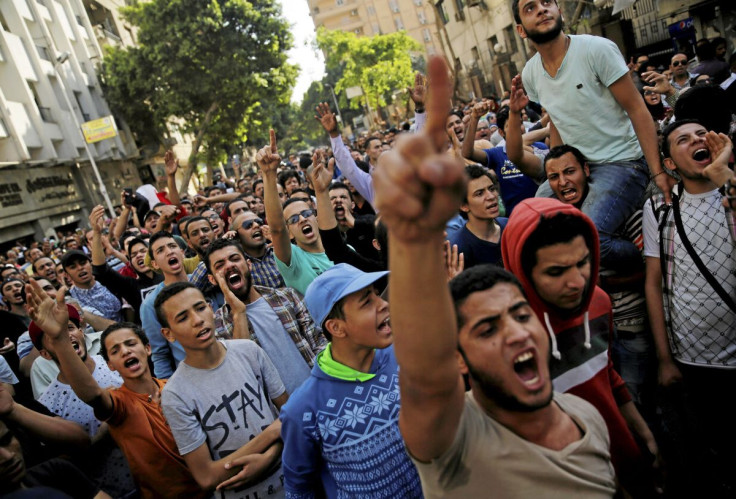 Egyptian protesters and Muslim Brotherhood members shout slogans against President Abdel Fattah al-Sisi and the government during a demonstration protesting the government's decision to transfer two Red Sea islands to Saudi Arabia, in front of the Press S