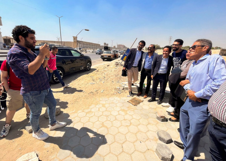 Alaa Essam, one of a group of newly released detainees, poses for photos with his family and friends and with Khaled Dawoud, a journalist and senior member of the liberal Dostour Party, after leaving Tora prison in a suburb of Cairo, Egypt June 2, 2022.