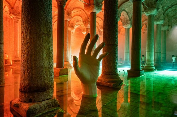 Modern works have been inserted for extra effect, such as a grasping hand emerging from the water