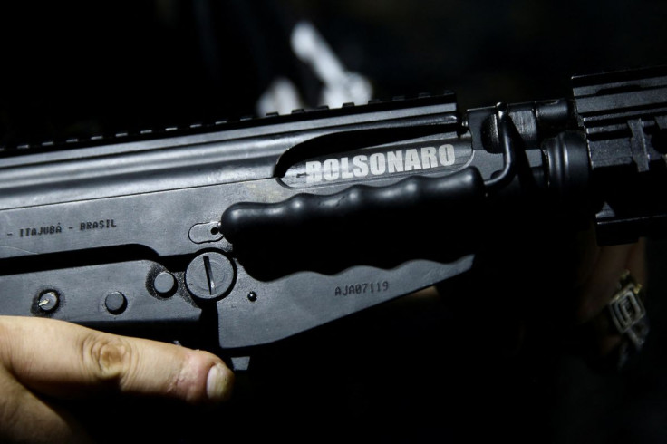 G16 shooting club president Gustavo Pazzini, holds a rifle which has a painting of the name of the Brazilian President Jair Bolsonaro during a practice session in Sao Paulo, Brazil July 28, 2022. 