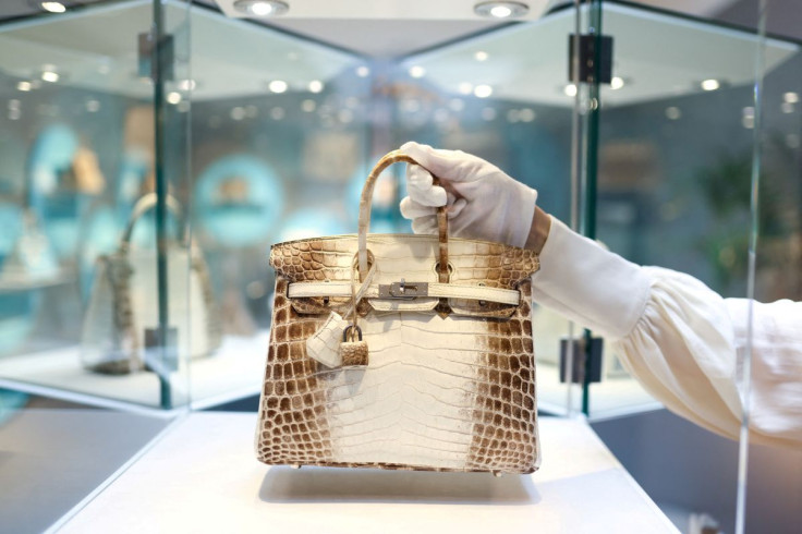 Rachel Koffsky, International Senior Specialist at Christie's Handbags & Accessories, poses with a piece titled "A rare, matte white himalaya niloticus crocodile Birkin 25 with palladium hardware, Hermes, 2013" which is on display as part of "Handbags Onl
