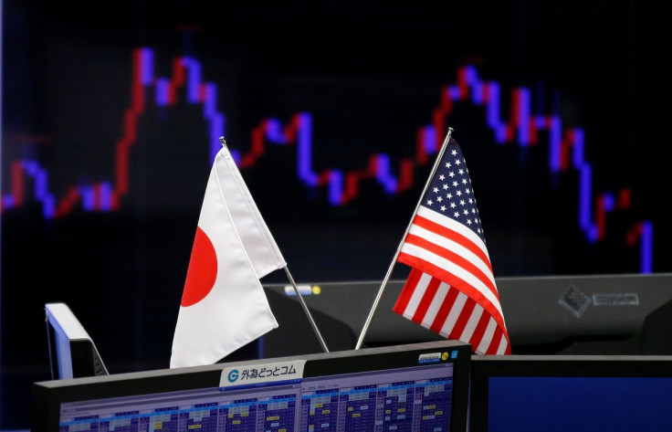 National flags of Japan and the U.S. are seen in front of a monitor showing a graph of the Japanese yen's exchange rate against the U.S. dollar at a foreign exchange trading company in Tokyo, Japan, January 23, 2017.