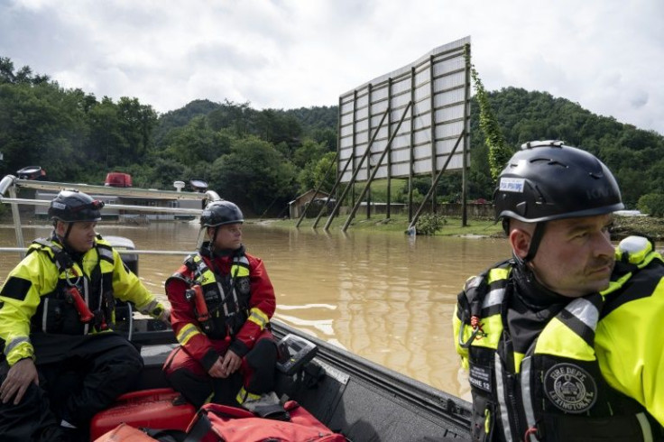 Firefighters head out to rescue people stranded by flooding in Lost Creek, Kentucky
