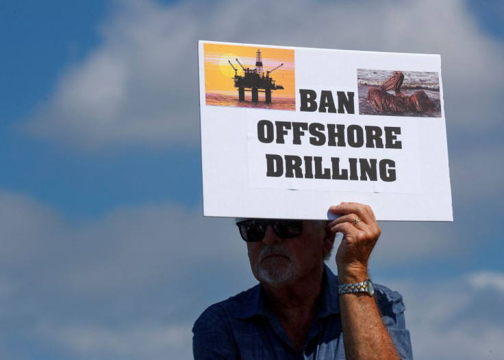 A person holds a sign in Encinitas, California, U.S., October 5, 2021. 