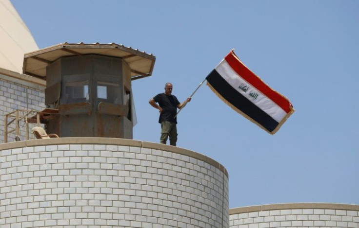 A Sadr supporter stands atop a watchtower at Iraq's parliament in the highly-fortified Green Zone