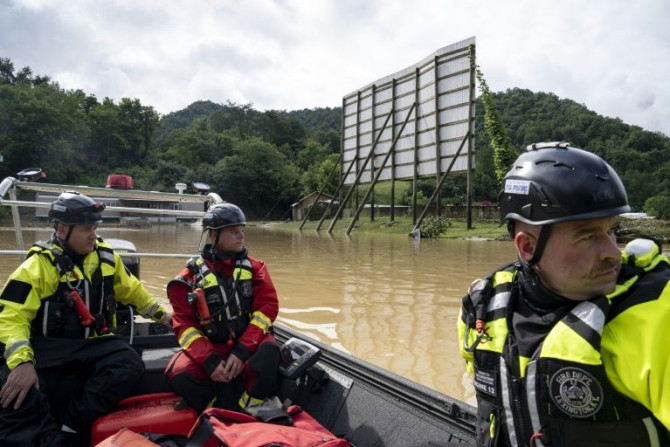 Firefighters warm up their boat's engine before heading up Troublesome Creek on July 29, 2022 to rescue people stranded by flooding in Kentucky