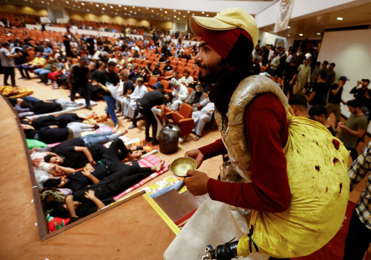 An Iraqi peddler sells juice as supporters of?Iraqi Shi'ite cleric Muqtada al-Sadr gather during a sit-in, inside the parliament building amid political crises in Baghdad, Iraq, July 31, 2022.