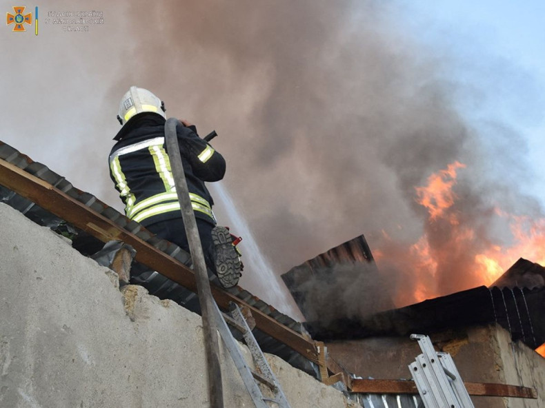 A firefighter works to douse a fire in a building, as Russia's attack on Ukraine continues, in Mykolaiv, in this handout picture released on July 31, 2022. State Emergency Service of Ukraine in Mykolaiv Region/Handout via REUTERS