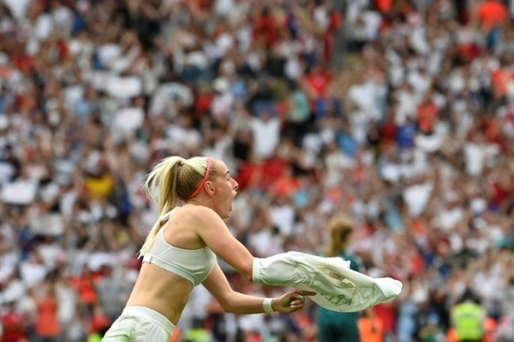 Shirt celebration: England's striker Chloe Kelly after the winning goal