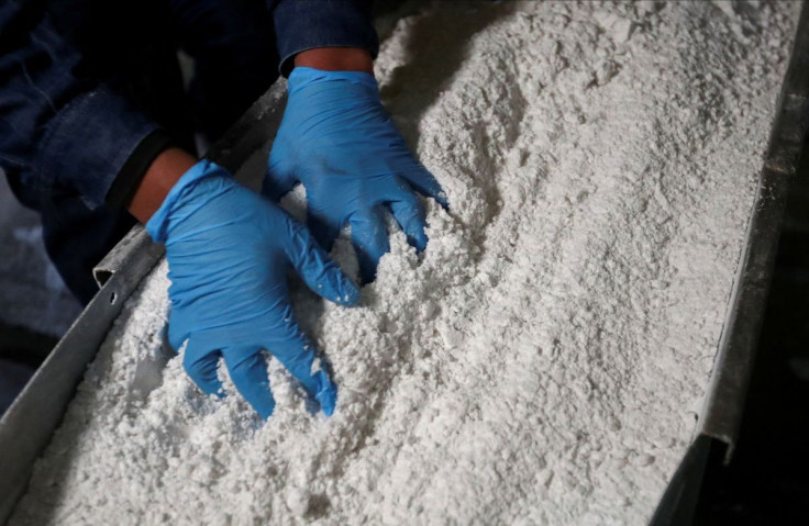 An employee grabs carbonate lithium after being processed in  Argentina August 12, 2021. 