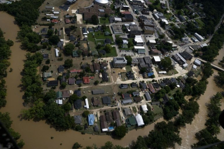 A residential neighborhood bordered by floodwaters is seen from a Kentucky National Guard recon and rescue mission flight on July 30, 2022 over Jackson, Kentucky