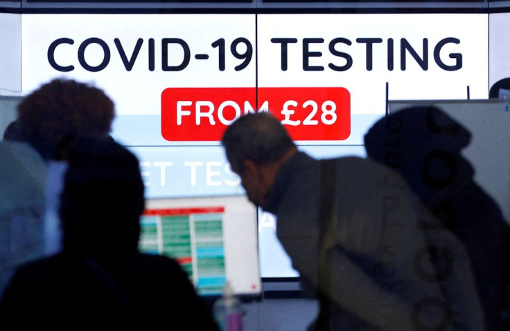 Customers are seen inside a private COVID-19 testing clinic in a busy shopping area, amid the coronavirus disease (COVID-19) outbreak in London, Britain, December 22, 2021.