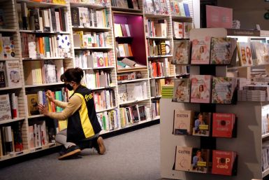 A staff member places books on shelves during preparations for the reopening of a Fnac store in Paris as part of an easing of the country's lockdown restrictions amid the coronavirus disease (COVID-19) outbreak in France, May 18, 2021. 