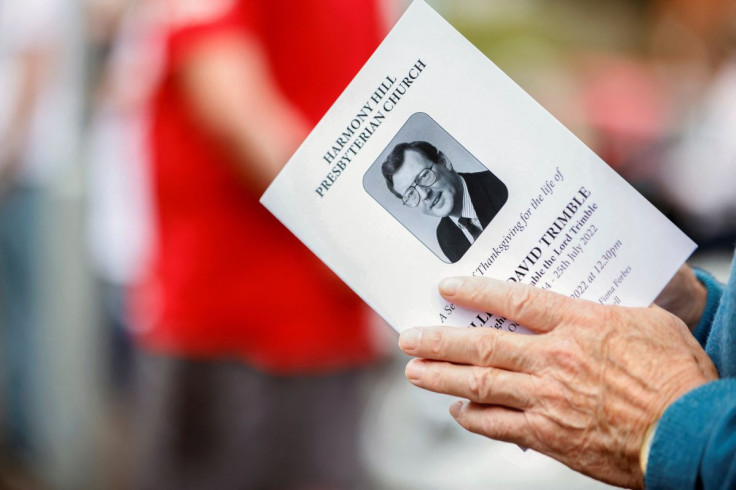 A person holds a funeral program as people gather for the funeral of Northern Ireland's former First Minister David Trimble, one of the key peace brokers of the Good Friday Agreement, at Harmony Hill Presbyterian Church, in Lisburn, Northern Ireland, Augu