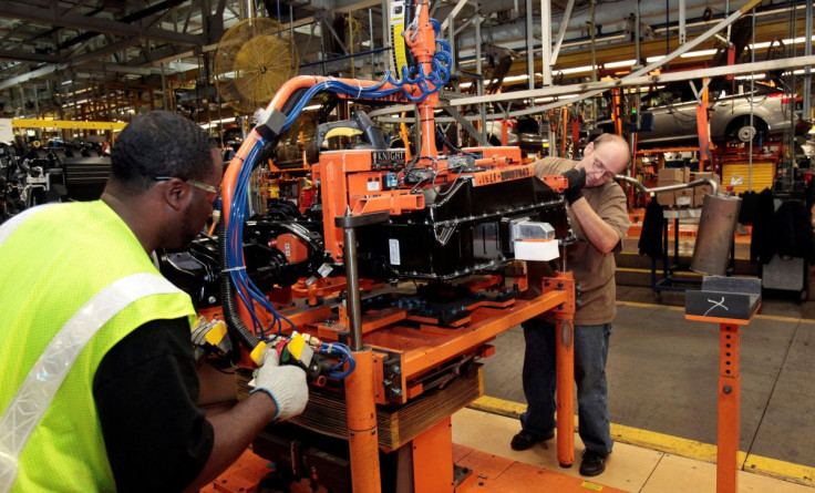 Ford Assembly workers install a battery onto the chassis of a Ford Focus Electric vehicle at the Michigan Assembly Plant in Wayne, Michigan November 7, 2012.  
