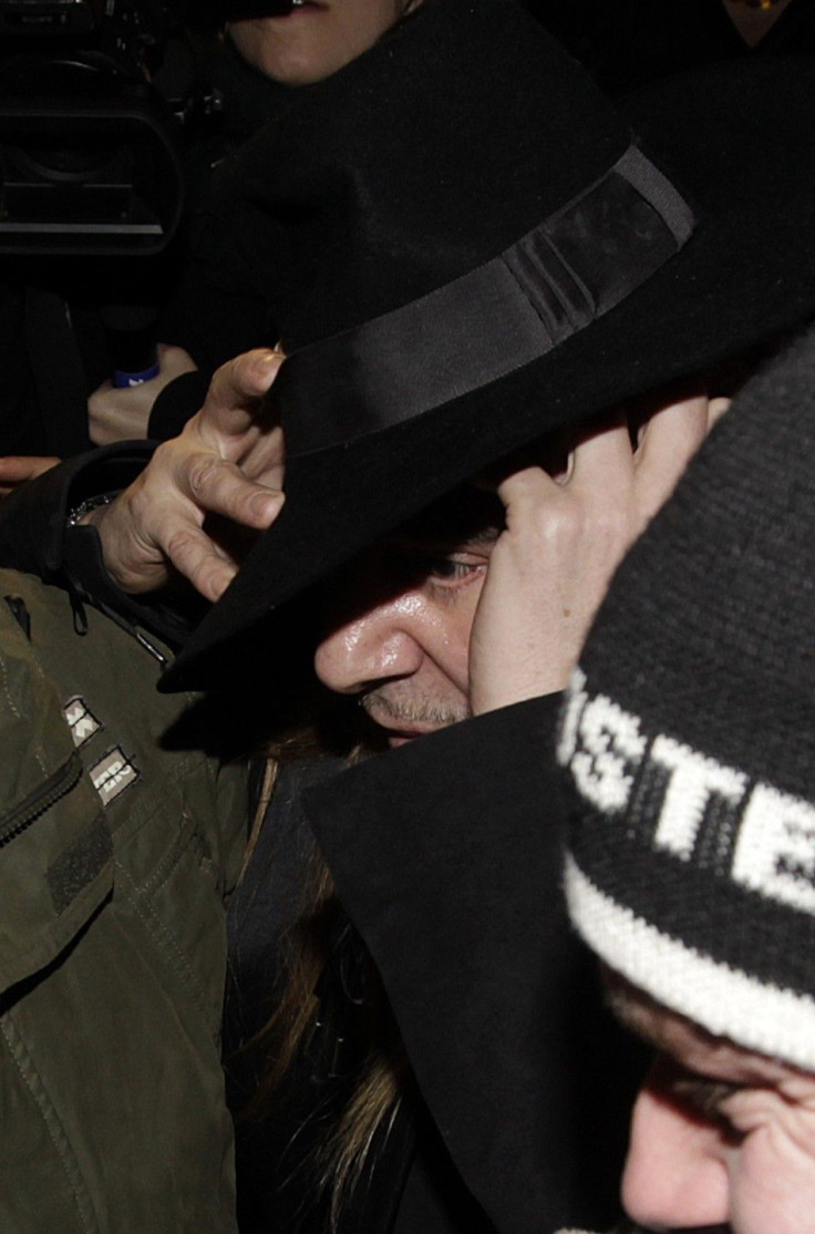 Fashion designer John Galliano leaves after a hearing in a police station in Paris