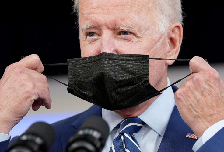 President Joe Biden removes his face mask prior to receiving his coronavirus disease (COVID-19) booster vaccination in the Eisenhower Executive Office Building's South Court Auditorium at the White House in Washington, U.S., September 27, 2021.