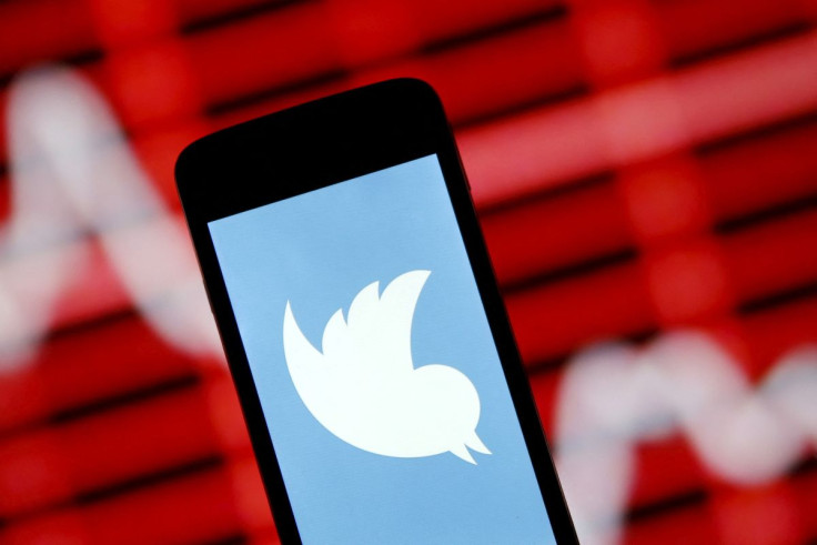 The Twitter logo is shown on a smartphone in front of a displayed stock graph in in this April 29, 2015 photo illustration.