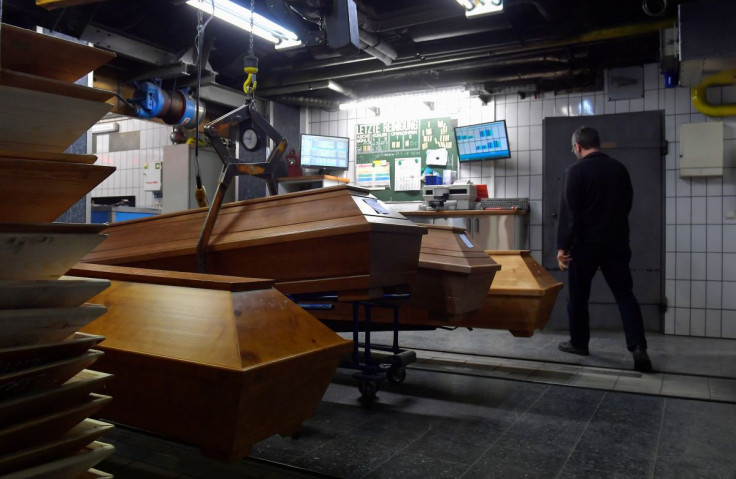 An employee prepares coffins for incineration in the Meissen crematorium amid the coronavirus disease (COVID-19) pandemic in Meissen, Germany, November 26, 2021.