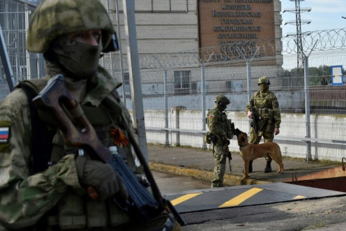 Russian servicemen patrol near the Kakhovka Hydroelectric Power Plant in occupied Kherson
