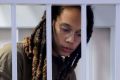 Griner was placed in a  defendants' cage for the court hearing in Khimki, outside Moscow