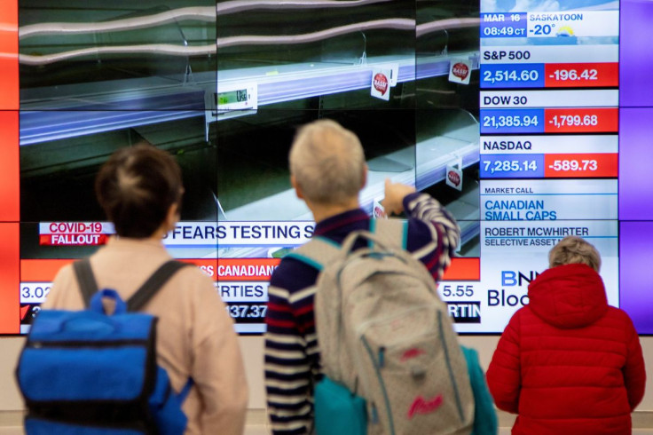 Monitors display the stock market numbers in the financial district in Toronto, Ontario, Canada March 16, 2020.