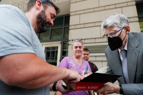 Novelist Stephen King gives autographs as he leaves the U.S. District Court on the day he testifies in an antitrust case against a publisher merger, in Washington, U.S., August 2, 2022. 