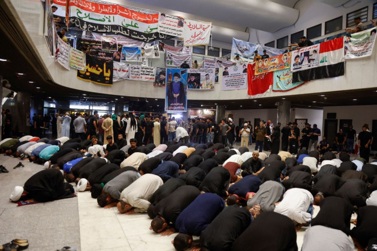 Supporters of Iraqi populist leader Moqtada al-Sadr pray during a sit-in, at the parliament building amid political crises in Baghdad, Iraq August 2, 2022. 