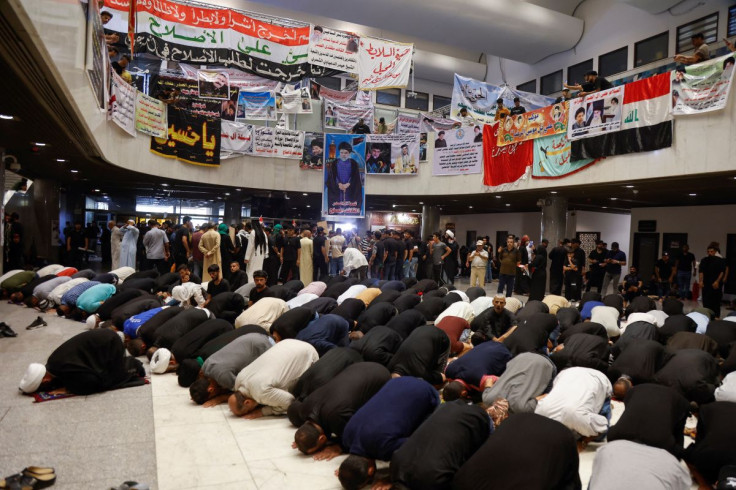 Supporters of Iraqi populist leader Moqtada al-Sadr pray during a sit-in, at the parliament building amid political crises in Baghdad, Iraq August 2, 2022.