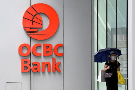 A woman walks by an OCBC signage in Singapore March 31, 2022. 