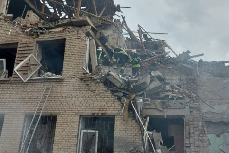 Rescuers work at a site of a school building destroyed by a Russian military strike, as Russia's attack on Ukraine continues, in the town of Mykolaivka, in Donetsk region, Ukraine, in this handout picture released August 2, 2022.  Press service of the Sta
