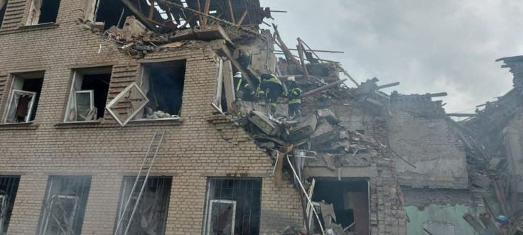 Rescuers work at a site of a school building destroyed by a Russian military strike, as Russia's attack on Ukraine continues, in the town of Mykolaivka, in Donetsk region, Ukraine, in this handout picture released August 2, 2022.  Press service of the Sta